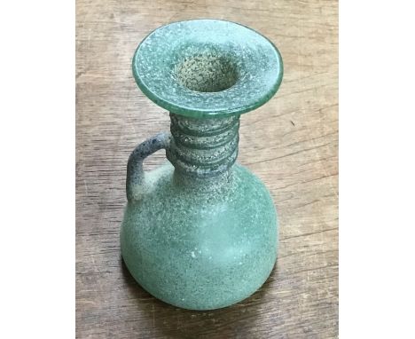 Late Roman glass grave offering flask. Approximately 11cm tall and 8cm wide.