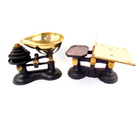 A cast iron kitchen scales, with a brass bowl and graduated cast iron and brass weights, and a further set of brass and cast 