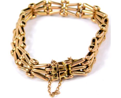 A 9ct gold X form gate bracelet, on a snap clasp with safety chain as fitted, 16.3g.