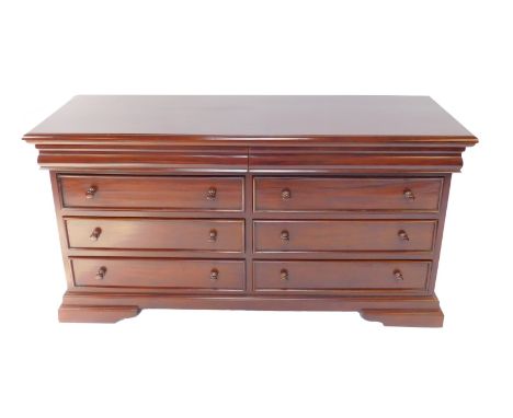 A Georgian style mahogany sideboard, with two cushion drawers over six further drawers, raised on a plinth base, over bracket