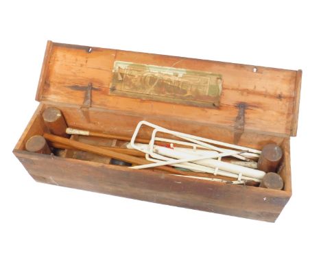 A Victorian croquet set, with mallets, irons and balls, cased, bears label for R M Collins, Sports Outfitter, Eastbourne.
