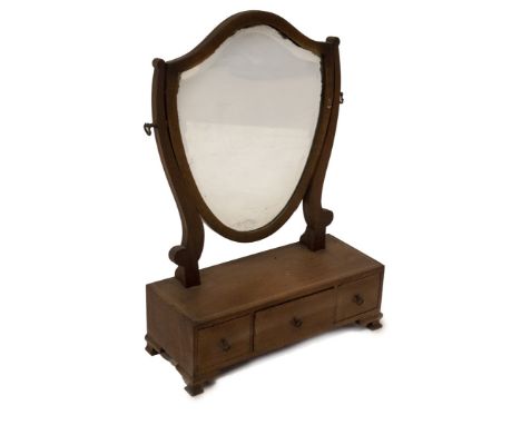 A 19thC mahogany dressing table mirror, with shield shape bevel plate, three drawer base with chevron stringing, brass loop h