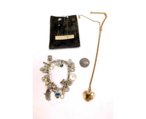 Five Victorian hat pins, one formed as a horseshoe, silver and enamel charm bracelet, George III Shilling 1787, and a plated 
