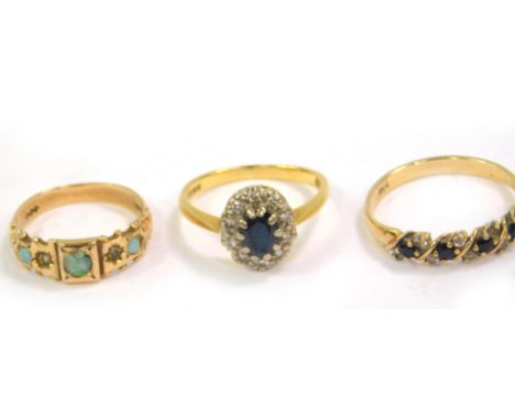 A 9ct gold and opal three stone ring, size M/N, 9ct gold sapphire and zircon ring, size T, and an 18ct gold sapphire and diam