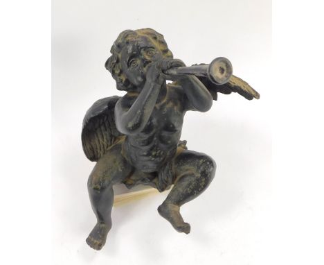 A black painted resin shelf figure modelled as a cherub playing a trumpet, 26cm H.