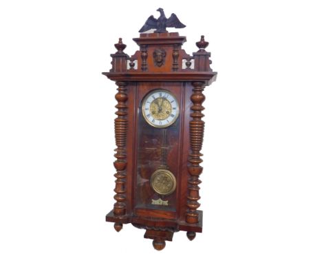 A late 19thC German walnut cased wall clock, circular brass dial, cast with thistles, enamel chapter ring bearing Roman numer
