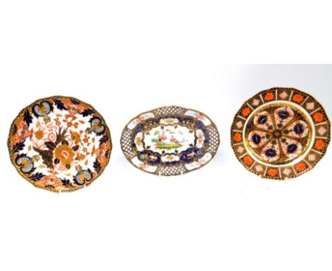 A Royal Worcester oval porcelain dish, circa 1897, painted with reserves of exotic birds fruit and roses against a cobalt blu
