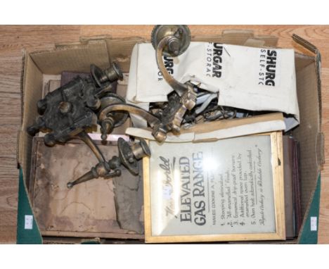 A box of mixed metalwares including vintage gas light fittings and advertising paperwork.