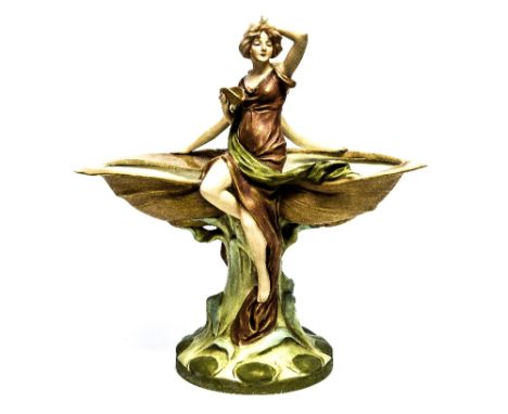 A Royal Dux twin girls, supporting two bowls, standing on a tree trunk base