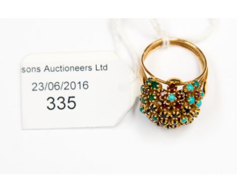 A Continental/Middle Eastern yellow metal cluster ring with turquoise, sapphire, emerald and ruby, ring size O, 6.7 grms appr