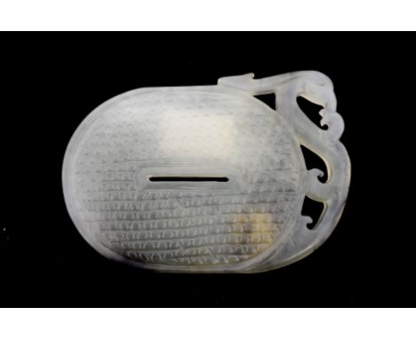 A carved jade plaque, hobnail pattern with archaistic dragon to the top, 10.5 cm