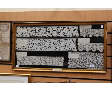 A large frame containing Italian 17th Century and 18th Century samples of bobbin lace, with descriptions, the frame inscribed