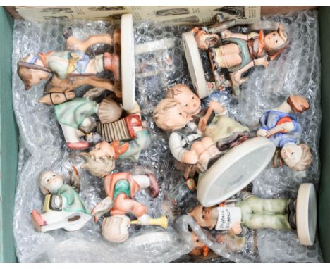 A collection of twenty-nine Goebel figures and figure groups, including soloist, school boy, apple tree boy, village boy, sur