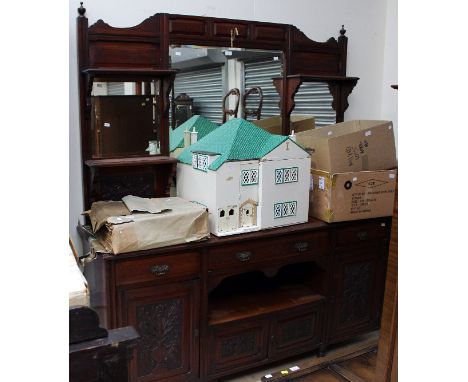 A late Victorian mahogany mirror backed sideboard, the base section with three drawers over four doors and an open shelf sect