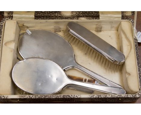 A Mappin and Webb silver backed dressing table set in original faux snakeskin case, including two brushes, mirror, and comb 