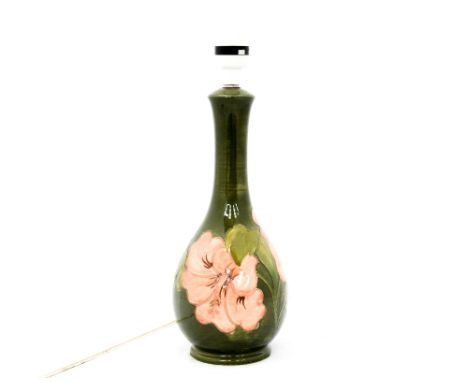 A Moorcroft lamp base circa 1935, possibly signed and with paper sticker (felt protection), green ground, 'Peach Hibiscus'
