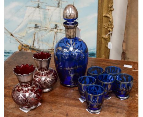 A 1950s Italian seven piece glass decanter set and a pair of similar ruby glass vases with silvered decoration (9)