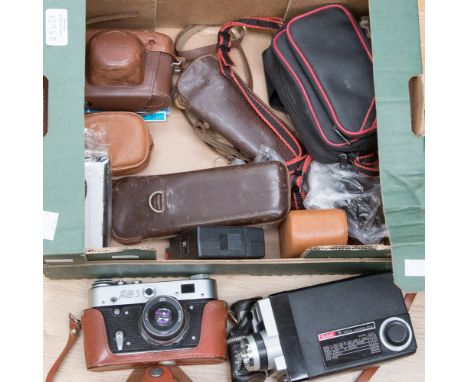 A box of assorted cameras, including Kodak flash light, a small disposable camera, two leather cased cameras and various othe