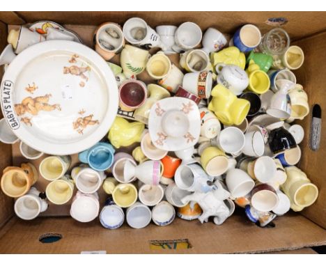 A box of assorted ceramic egg cups and a baby's plate printed with bears doing sports (1 box)