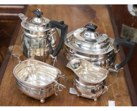 A Victorian four piece silver boat shape tea service with gold rim border, raised on four ball feet, London 1865/1866, weight