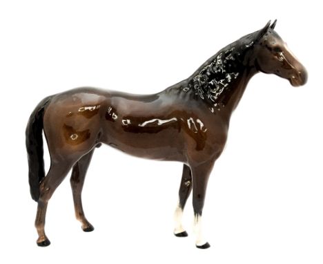 A large Beswick bay racehorse stallion, tail touching rear leg