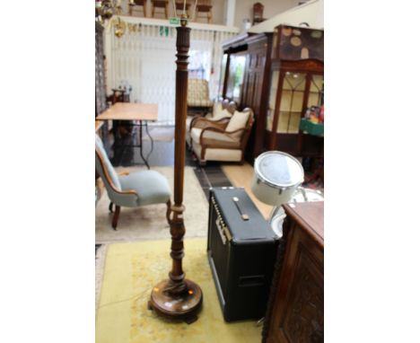 A mid 20th Century beech standard lamp, standing on a circular base
