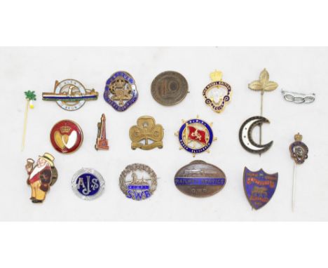 A collection of badges GWR British legion, a silver and enamel South Wales Borderers badge, Royal Artillery etc, in a jar (18