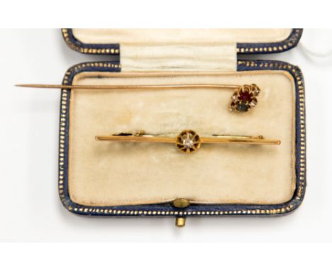 A 9 ct Victorian bar brooch set with a diamond, an Edwardian rose metal cravat stick pin set with ruby, sapphire and diamonds