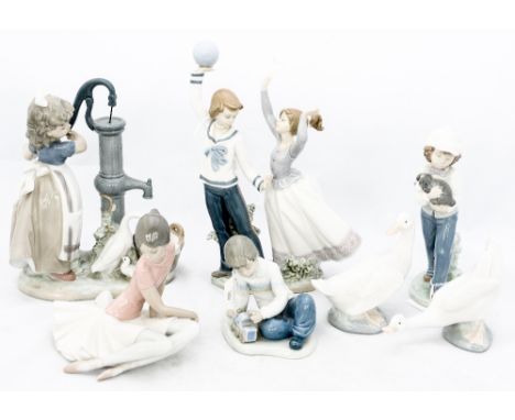 A collection of three Lladro figures of a boy and a girl with a ball, a girl at a water pump and a seated ballerina, together