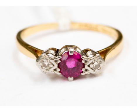 An 18 ct gold ruby and diamond three stone ring, size K approx.