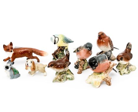 A Beswick 'Fox' and six Beswick birds 'Blue Tit', 'Wren', 'Chaffinch', 'Robin', 'Bullfinch' and Lady and Jock Wade Whimsies (