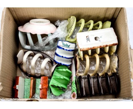 A collection of Carlton ware toast racks and various others including one in the form of a cottage