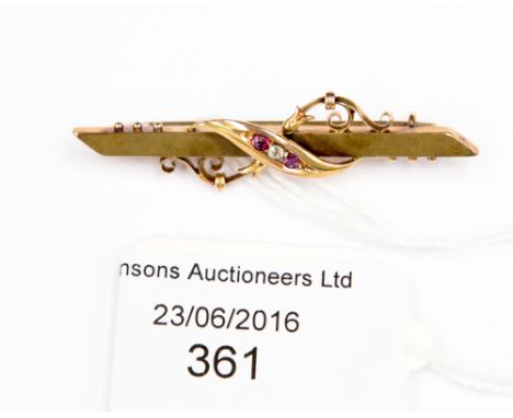 A 15 ct gold diamond and ruby bar brooch with scrolled design, late 19th, early 20th Century 3.7 grms approx. 