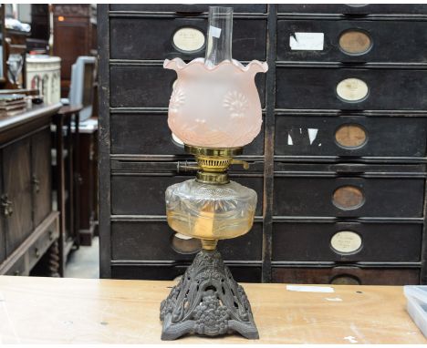  A late Victorian cast iron and glass oil lamp with pink frosted glass shade, in the Art Nouveau style, Duplex wick
