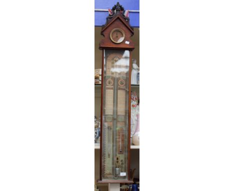 A mercury barometer with chemical weather glass and thermometer, paper shipping labels, clock insert