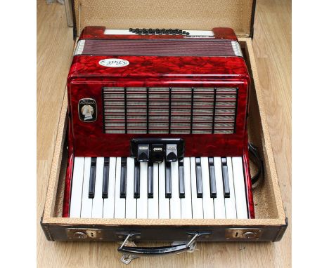 A cased piano accordion, A Bell, 'Stella Wetmeister', red plastic marbled effect, good condition
