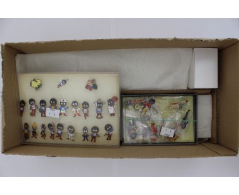 A collection of Robertson's Golly enamel badges and pottery band figures