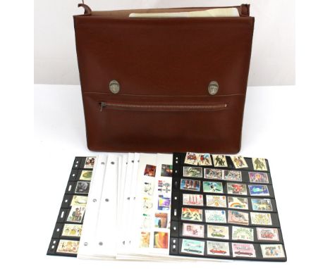 Two stamp albums and first day covers providing some mint GB face value in a leather briefcase