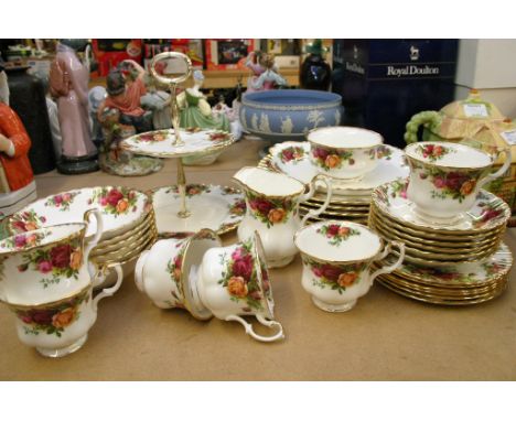 A Royal Albert old English country rose pattern part service comprising diner plates cake stand cups and saucers etc 
