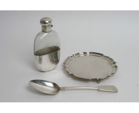 A collection of silver comprising a hip flask, card tray and a Georgian table spoon. 