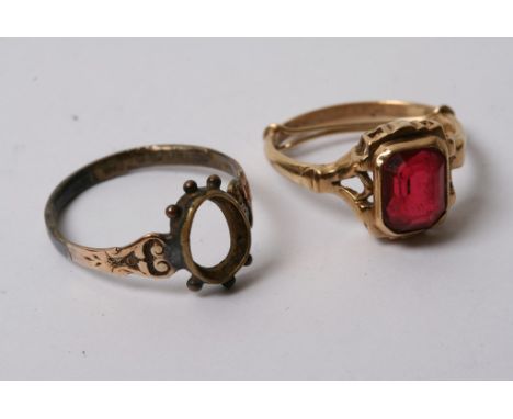 A 10ct gold ring inset with a red stone and one other gold ring (2) 