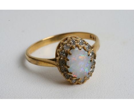 A 9ct gold ring inset with an opal and diamonds