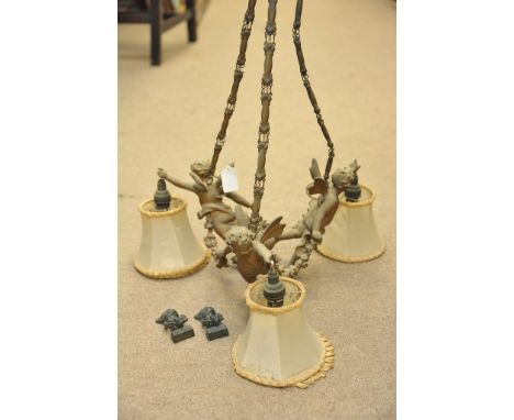A quality early 20th century light fitting in the form of three gilded metal winged cherubs 