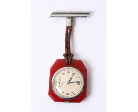 An unusual Art Deco style button wind fob watch set in red Bakelite type mount