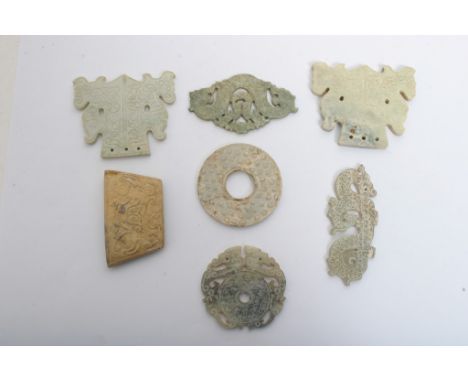 A collection of eight Chinese hard stone carvings of various archaic designs, some possibly jade