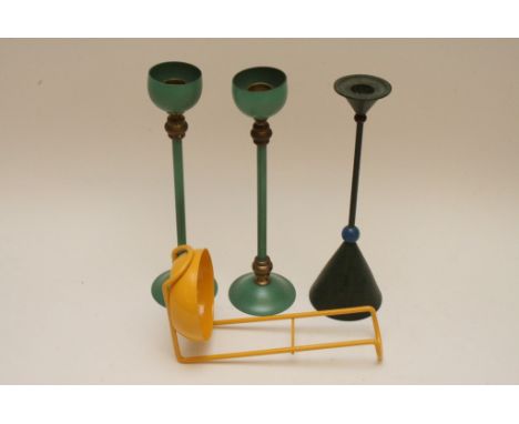 A group of modern design items comprising a pair of green and gold metal candlesticks with raised circular bases with spindle