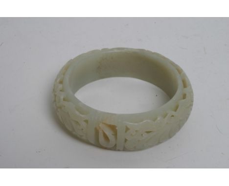 A well detailed carved jade bangle with pierced and foliate design. 