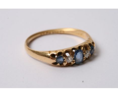 An 18ct gold ring set with diamonds and sapphires