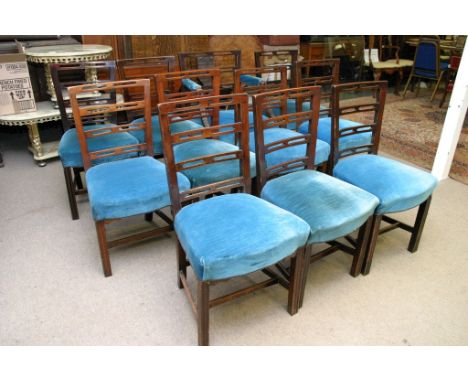 A set of eleven George III mahogany ladder back dining chairs with blue upholstered stuffover seats including one carver