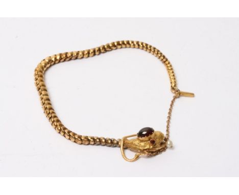 A vintage 18ct gold bracelet in a form of a snake inset with ruby eyes and a cabochon articulated graduating links 